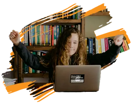 photo of a tween girl with a laptop in a library, raising her hands in victory (Education Revolution Resources page)