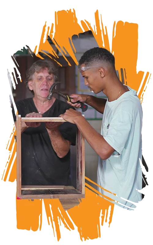 photo of a high school student learning carpentry with a mentor