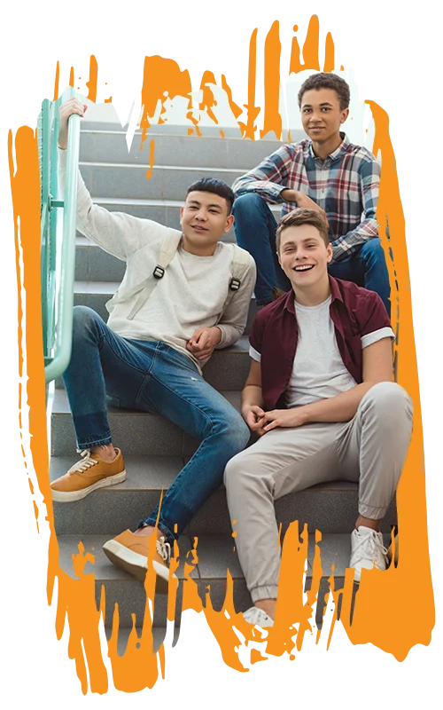 photo of a three male high school students handing out on the stairs of their school building (Life Discovery FAQs page)