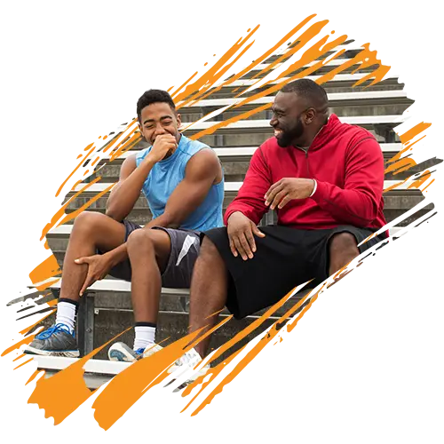 stylized photo of a male teacher and student sitting on bleachers talking and laughing (About Education Revolution Association page - Our Mission)